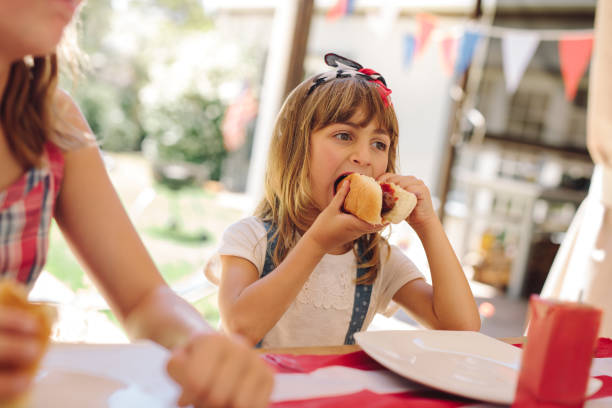 istock Little girl eating snacks at a restaurant 1096935466