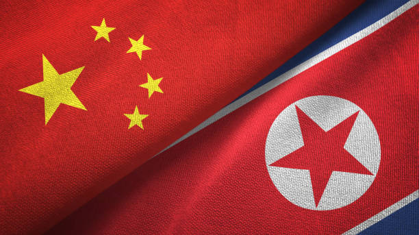istock North Korea and China two flags together textile cloth, fabric texture 1096942934