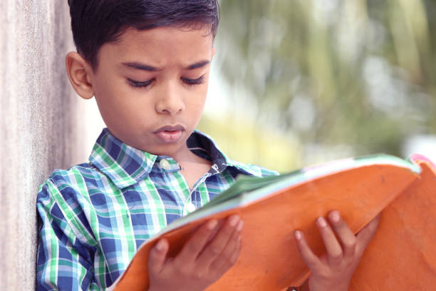 istock Indian Little Boy Posing to Camera with Textbook 1096945444