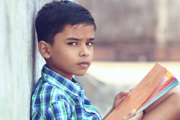 istock Indian Little Boy Posing to Camera with Textbook 1096945630