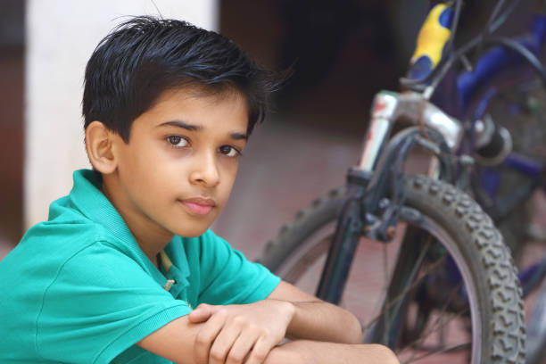 istock Indian Cute Boy with Cycle 1096946070