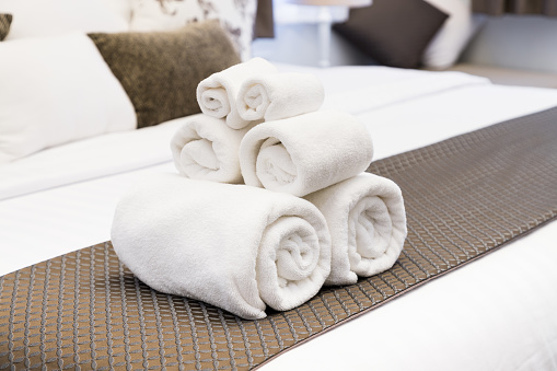 White towel roll on hotel resort bed