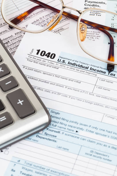 istock Tax form with glasses, and calculator 1096948744