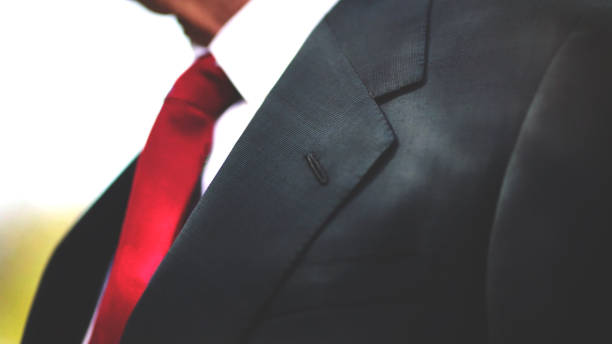 istock men with black business suit and red tie 1096951762