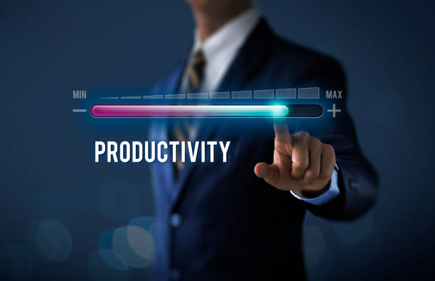 istock Increase productivity concept. Businessman is pulling up progress bar with the word PRODUCTIVITY on dark tone background. 1096951974