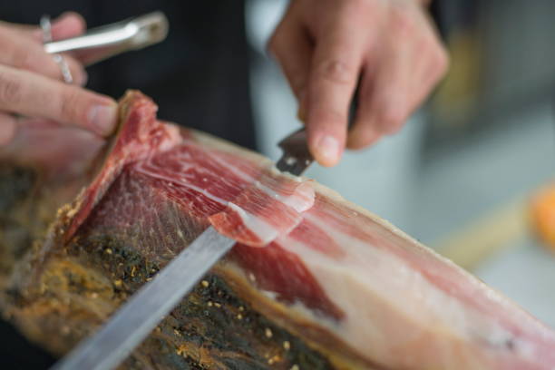 Slicing Spanish ham. stock photo