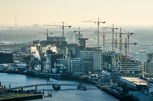Rotterdam, The Netherlands, January 2019: Winter morning view of an ensemble of construction cranes building new residential blocks around the Katendrecht grain silo