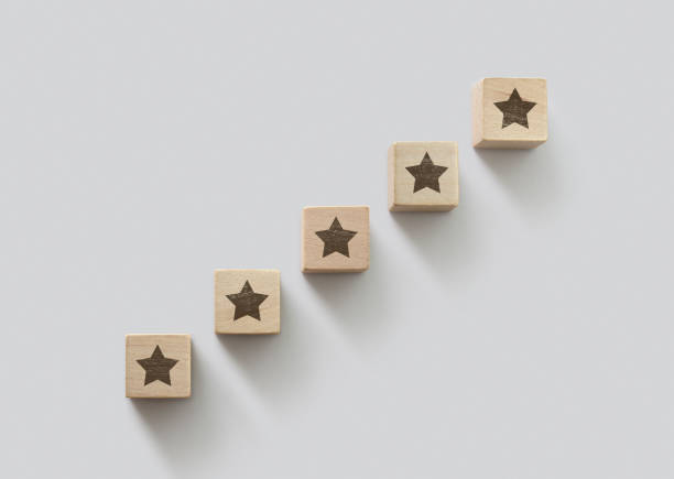 Wooden blocks arranged in stair shape with the five star symbol. The best rating, the best ranking, the best service, goal, success concept. stock photo