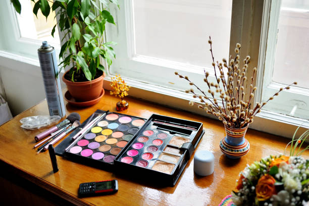 istock Professional pallet of eyeshadow. Multicoloured eye shadows, brushes and other make-up tools lie on the windowsill. 1096955134