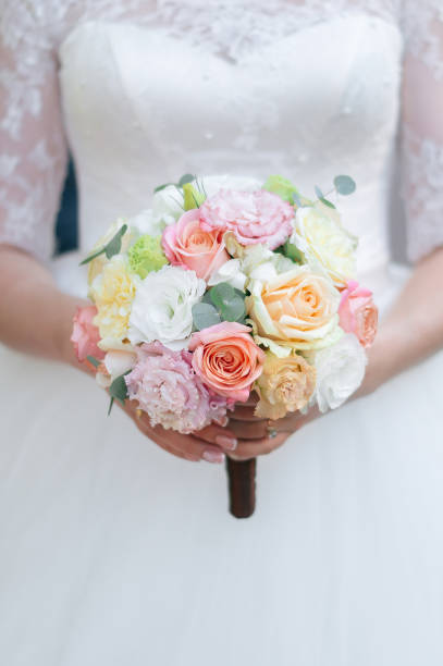 istock Round wedding bouquet with white pink and peach roses 1096956518