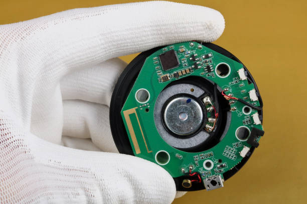 istock A technician controls the quality of a bluetooth  module for mobile audio devices. Mass production 1096957274