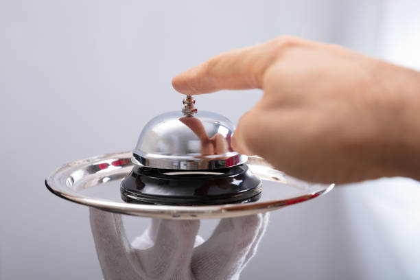 istock Person Ringing Service Bell Held By Waiter 1096960006