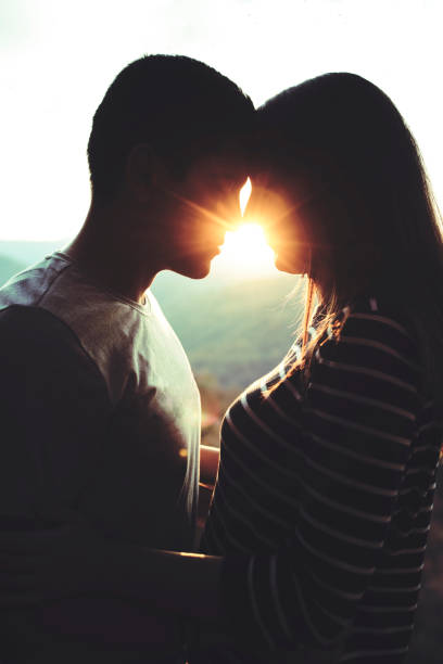 istock Beautiful young couple in love at sunset 1096960792