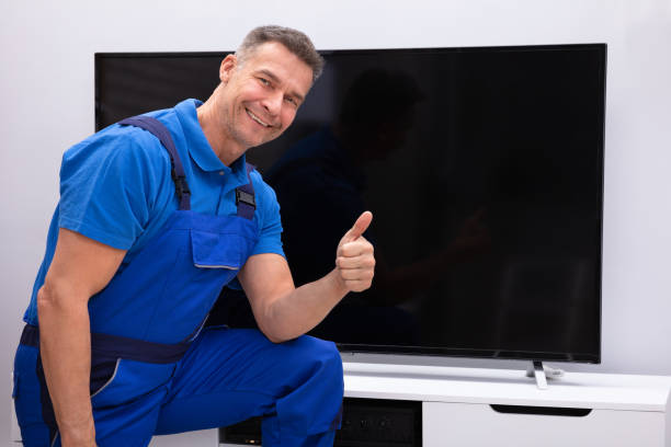 istock Happy Technician Showing Thumb Up Near Television 1096963696