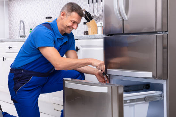 Serviceman Repairing Refrigerator Mature Male Serviceman Repairing Refrigerator With Toolbox In  Kitchen fridge problem stock pictures, royalty-free photos & images