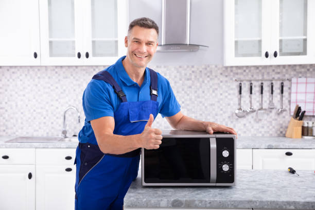 istock Man Repairing Microwave Oven 1096969726