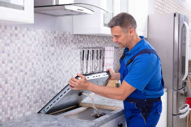 istock Repairman Installing Induction Stove 1096969750