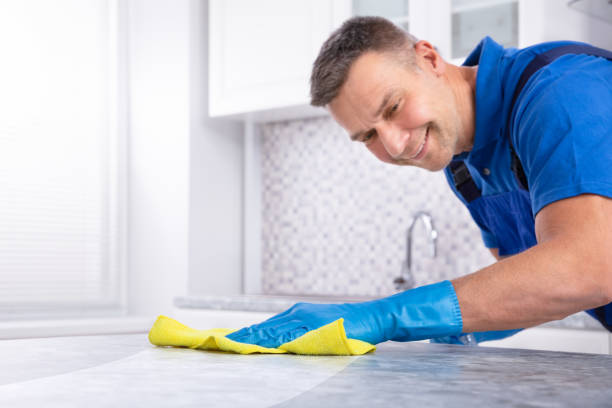 istock Male Janitor Cleaning Kitchen Counter 1096969770