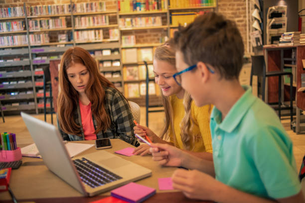 istock friends having fun studying together in the library 1096974214