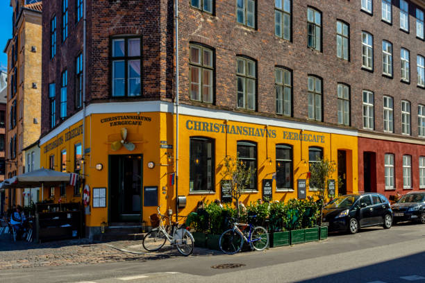 Bicycles outside an old cafe (Christianshavn Faergecafe) with door and window with shutters in Copenhagen.