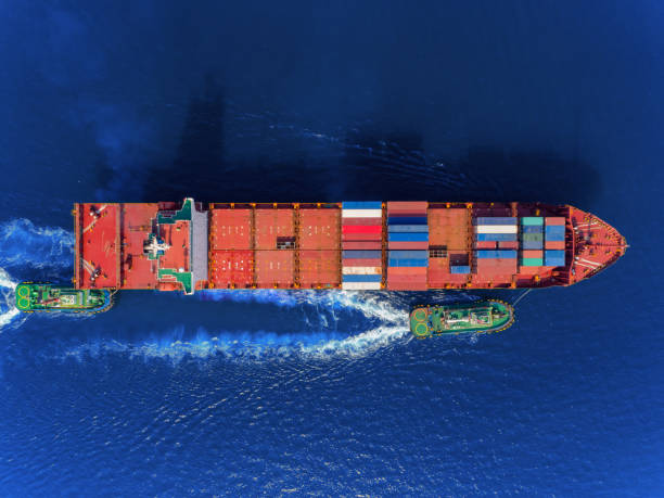 istock Aerial top view Tugboat draging container ship to sea port for loading container, logistics import export, shipping or transportation concept background. 1096979690
