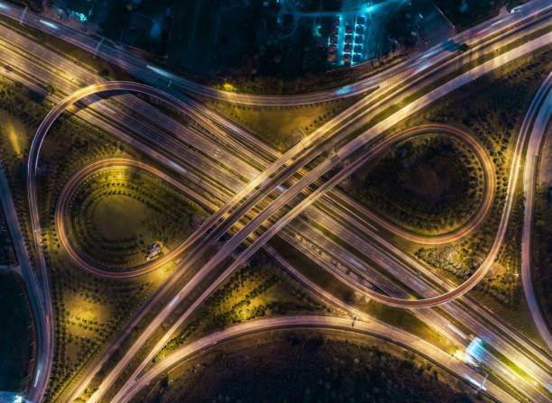 istock Aerial top view highway road intersection roundabout or circle at night for transportation, distribution or traffic background. 1096979972