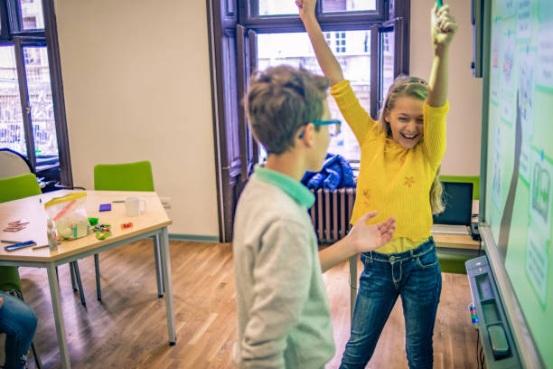 istock cheerful school friends working together on a project 1096983142