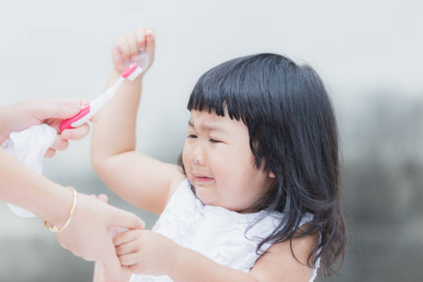 istock Adorable girl  against practice or learning for brush teeth. 1096987466