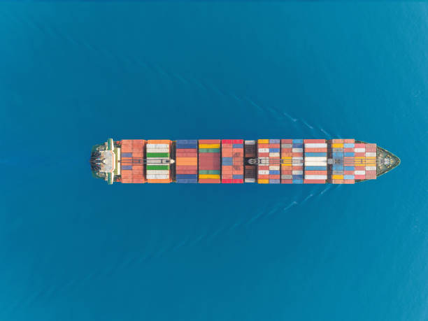 istock Aerial top view container ship at sea port and working crane bridge for loading container, logistic business, import export, shipping or transportation. 1096990118