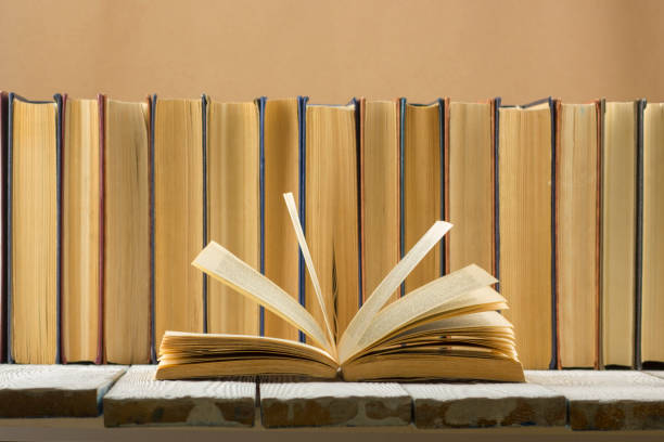 istock Open book, hardback books on wooden table. Back to school. Copy space. 1096992296