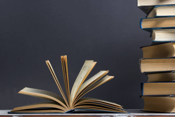 istock Open book, hardback books on wooden table. Back to school. Copy space. 1096992338