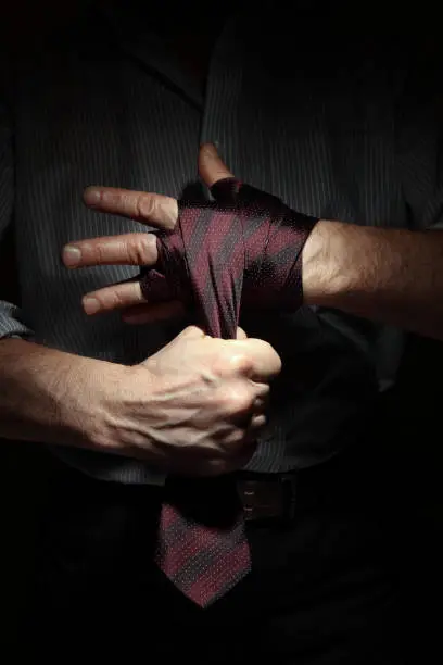 Concept image of man getting ready for office fight with a tie on his fist