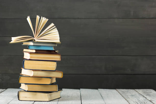 istock Open book, hardback books on wooden table. Back to school. Copy space. 1096992670