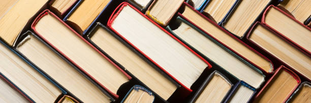 istock Open book, hardback books on wooden table. Back to school. Copy space. 1096992700