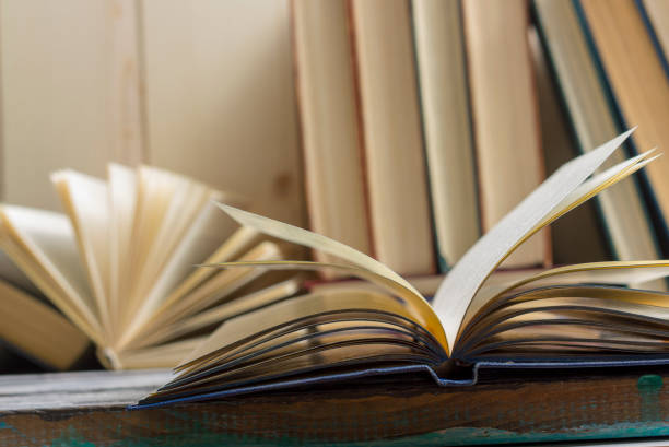 istock Open book, hardback books on wooden table. Back to school. Copy space. 1096992902