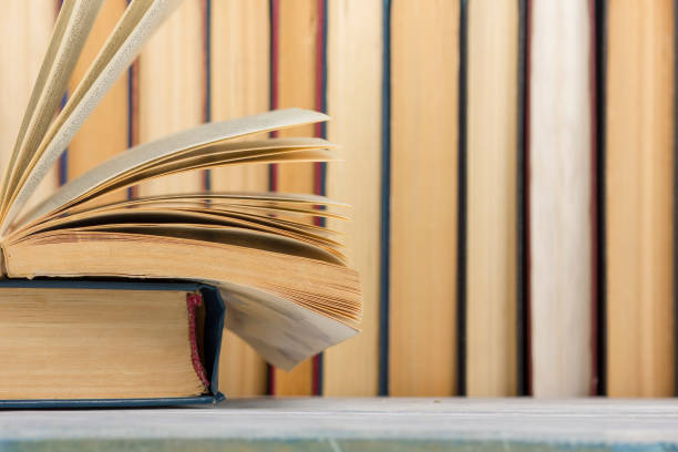 istock Open book, hardback books on wooden table. Back to school. Copy space. 1096993586