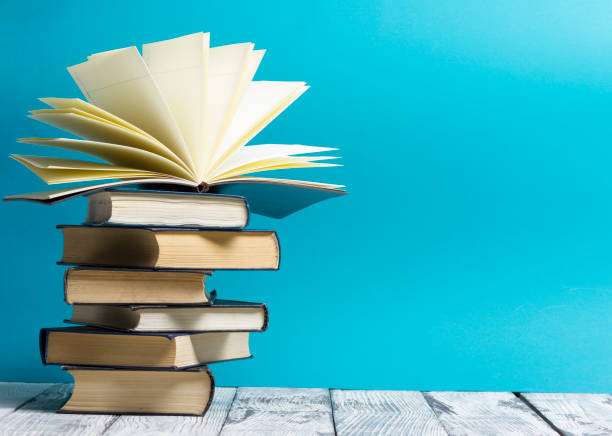 istock Open book, hardback books on wooden table. Back to school. Copy space. 1096994044