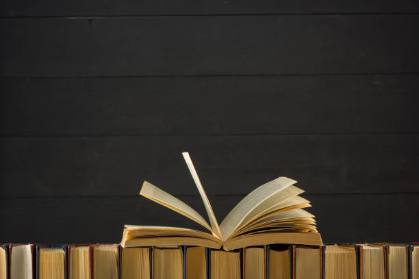 Open book, hardback books on wooden table. Back to school. Copy space.