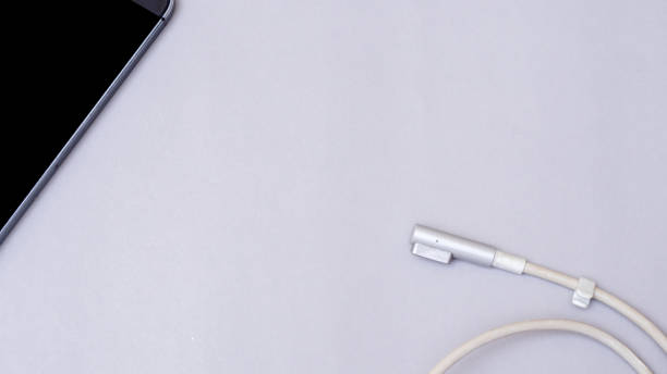istock smart phone and charger on gray background business concept desk table 1096995206