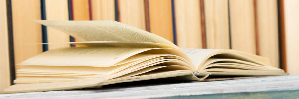 istock Open book, hardback books on wooden table. Back to school. Copy space. 1096995532
