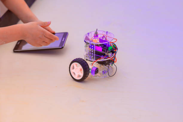 istock Assembled model of a computer all-terrain vehicle, robotic toy controlled with tablet in the hands of a child 1096996502