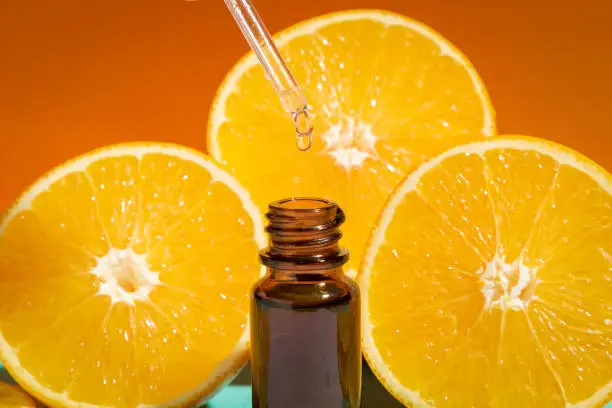Bottle with drop essential oil orange