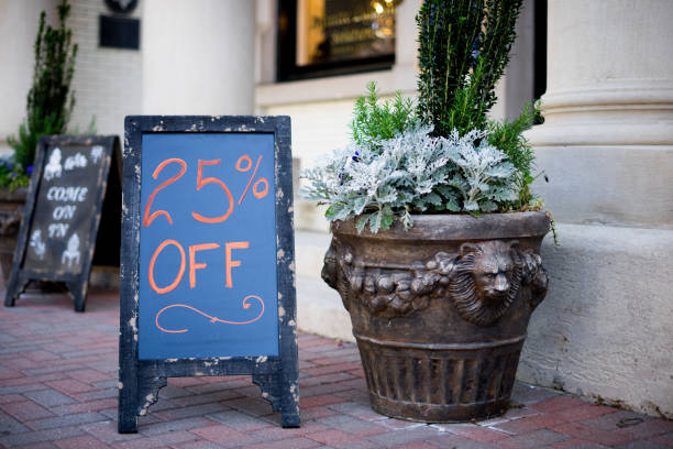 Homemade farmhouse style chalkboard 25% off sign outside a small business stock photo
