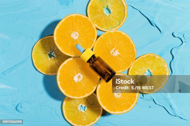 Bottle With Essential Oil Orange Lies On Fresh Oranges Stock Photo - Download Image Now