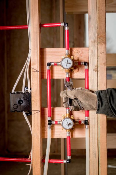 istock Master plumber uses pliers to crimp a fitting 1097009508