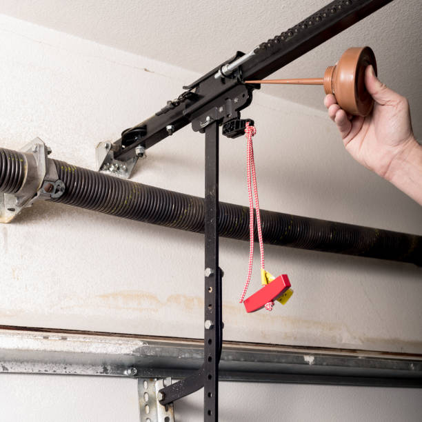 istock Man oils the quick release of a garage door opener to keep it working smoothly 1097010244
