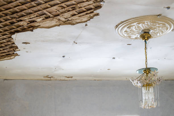 istock ruined old ceiling and hanging lamp 1097010562