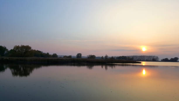 istock Warm solar evening on the quiet lake 1097015128