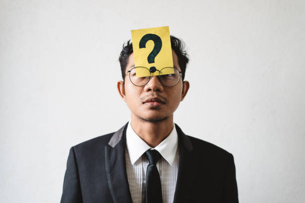 istock Businessman With Question Mark Sign Against White Background 1097015494