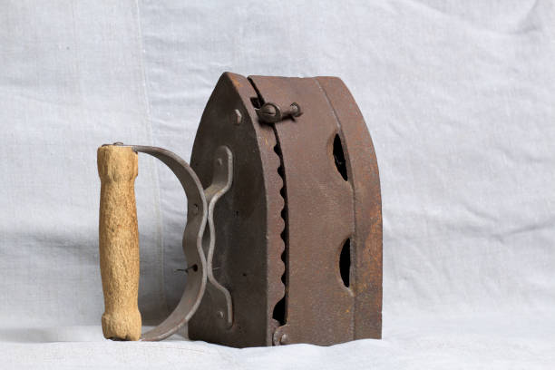 istock Old iron, heated by hot coals. Located on linen fabric. 1097019772